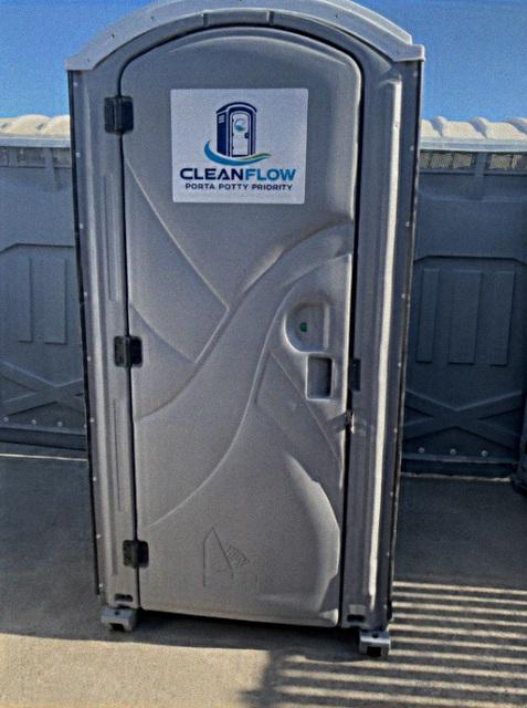 Standard portable toilet unit staged and ready for use on a job site